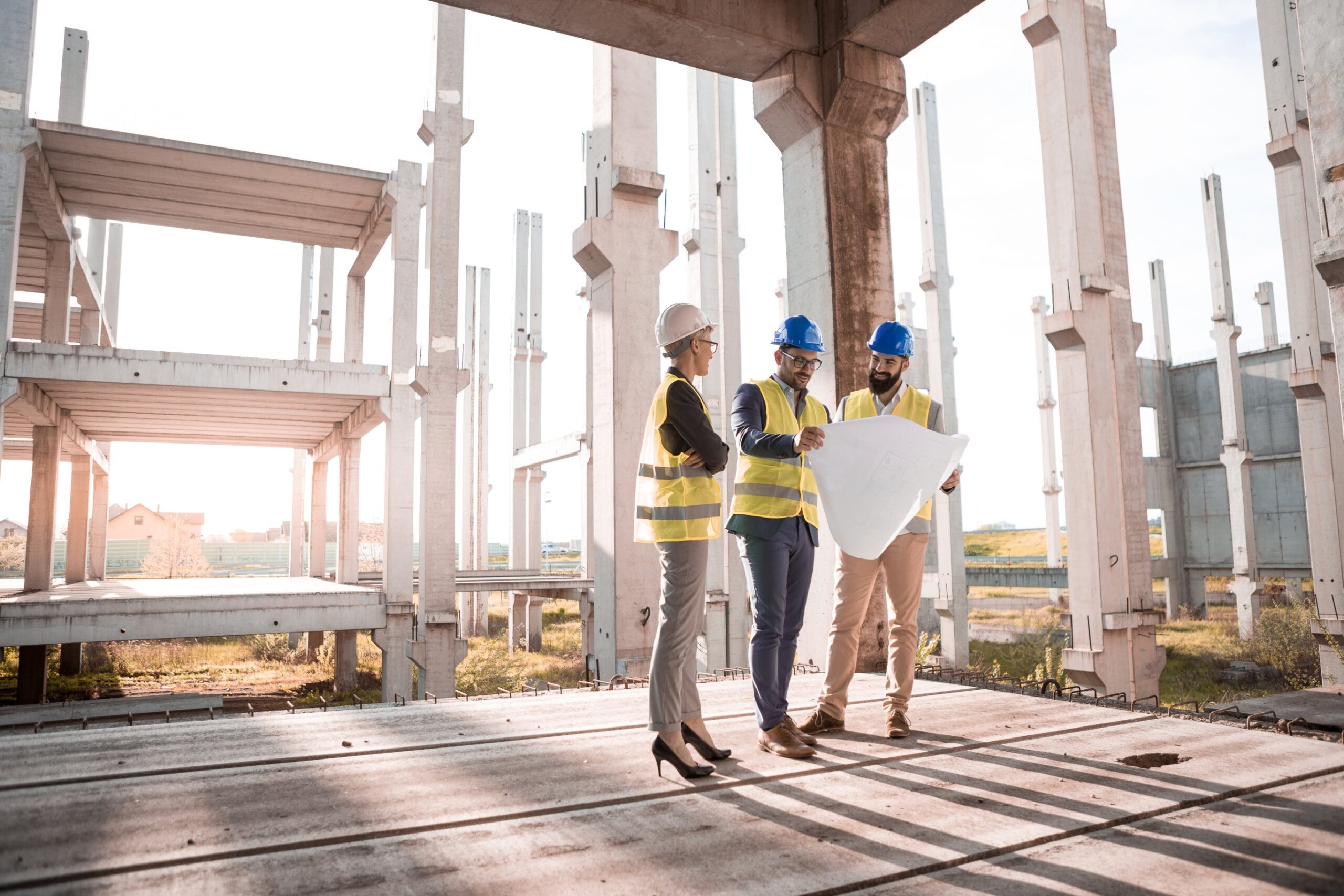 Construction team reviewing blueprints on site.