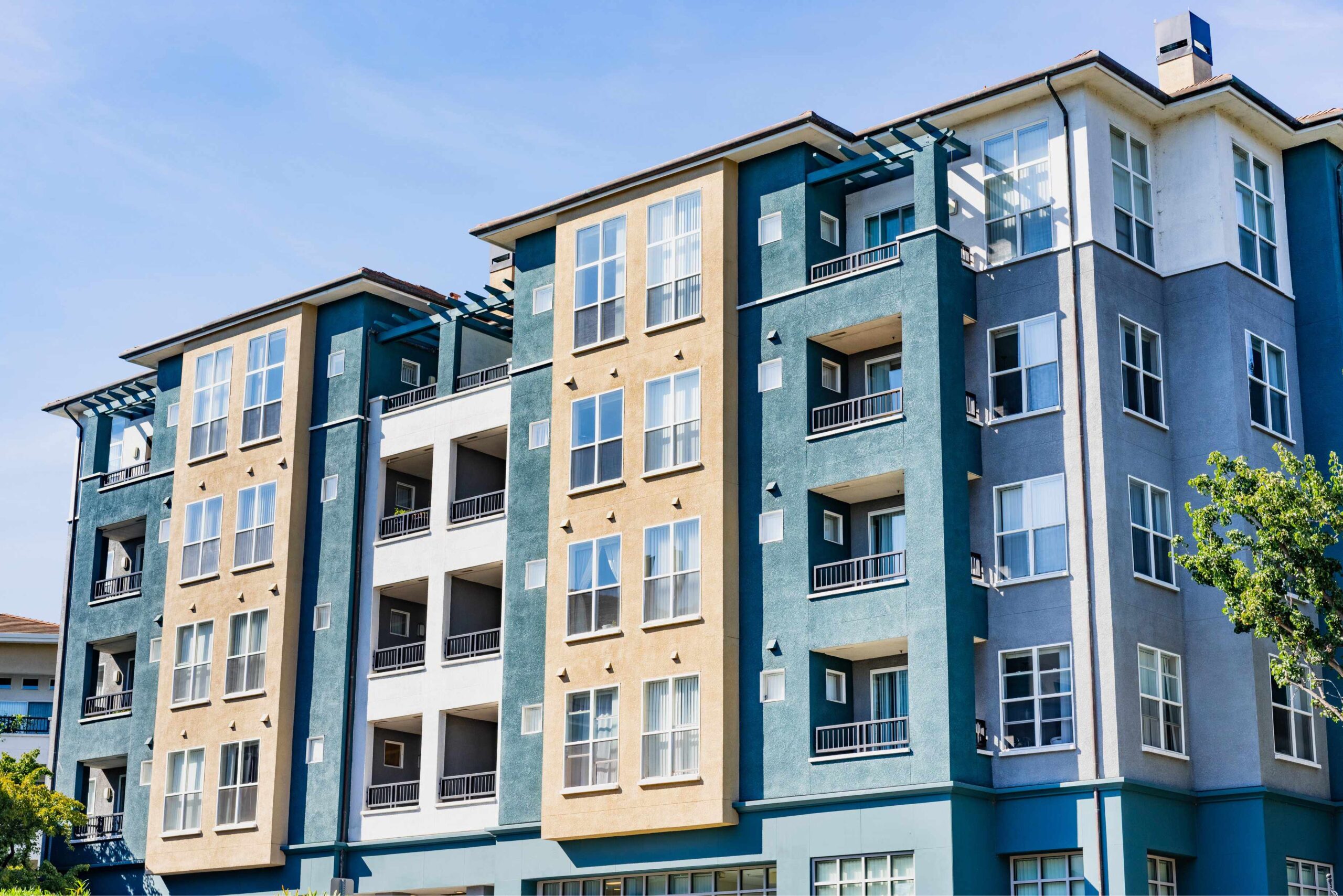 Modern apartment building under clear blue sky.