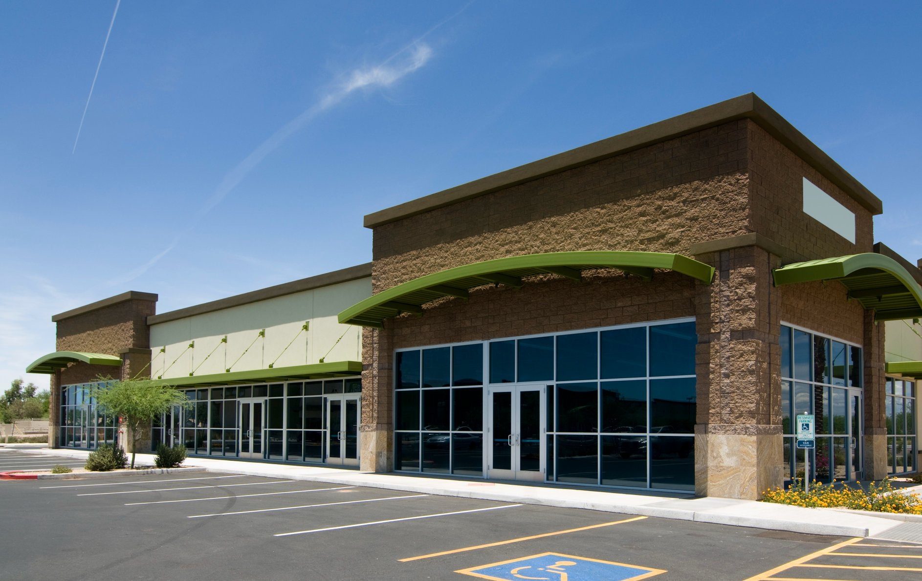 Empty commercial building with large glass windows.