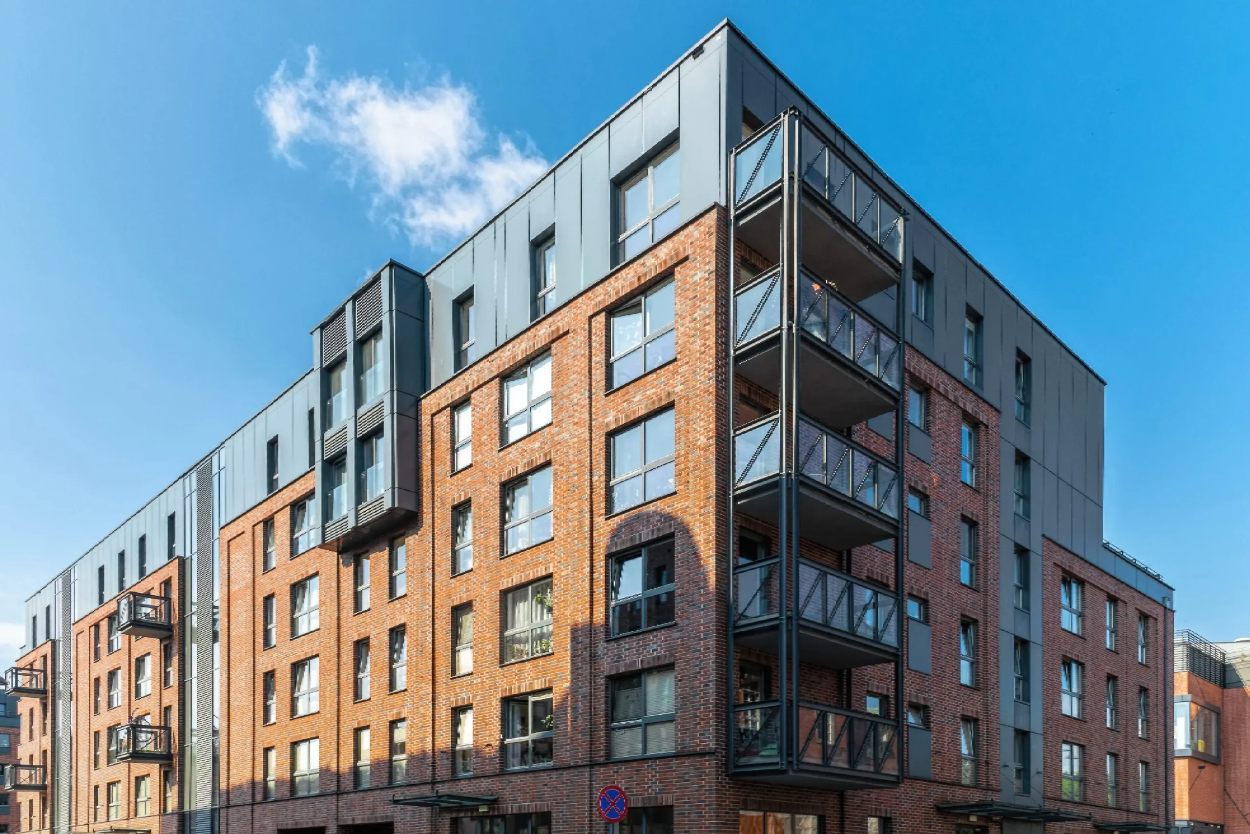 Modern apartment building with balconies and windows.