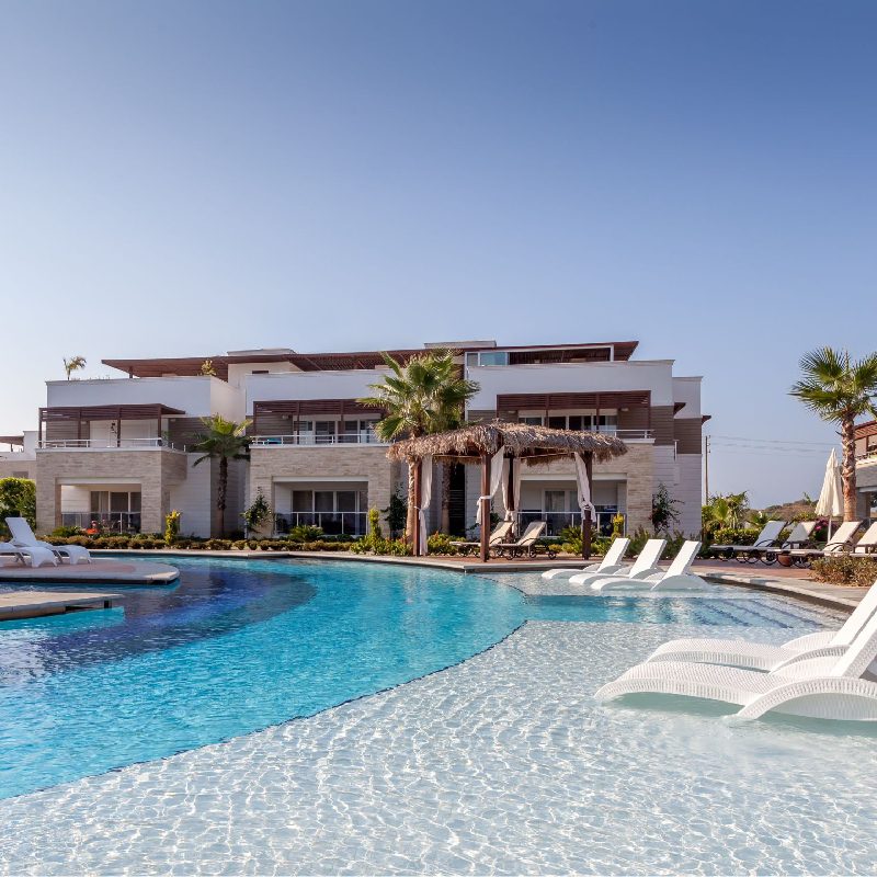 Luxury resort pool with lounge chairs.
