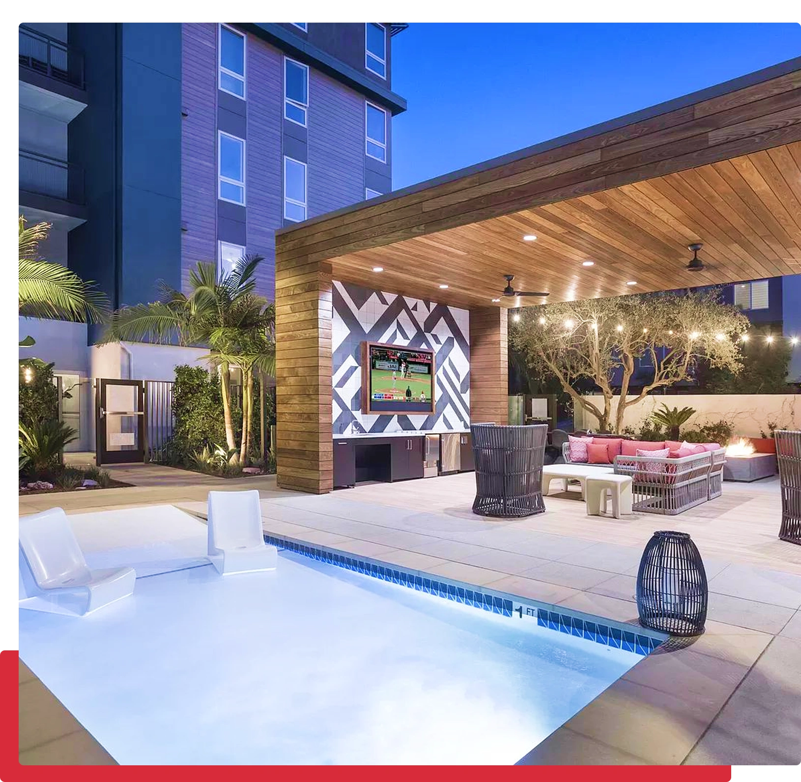 Modern poolside lounge with outdoor TV setup.
